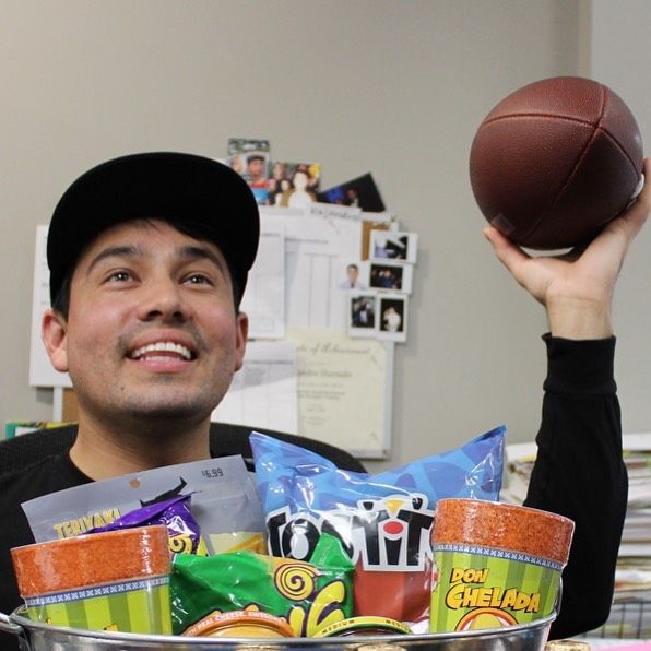 Staff member holding football and bucket of snacks